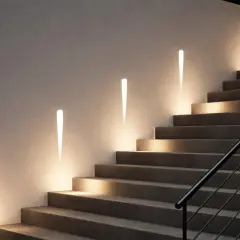 Nowoczesne oświetlenie LED schodów wpuszczane w ścianę z czujnikiem ruchu. Eleganckie, stożkowe lampy subtelnie rozświetlają stopnie.