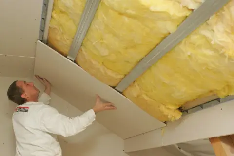Ocieplanie dachu kopertowego wełną mineralną. Montaż płyty gipsowo-kartonowej, by uniknąć mostków termicznych.