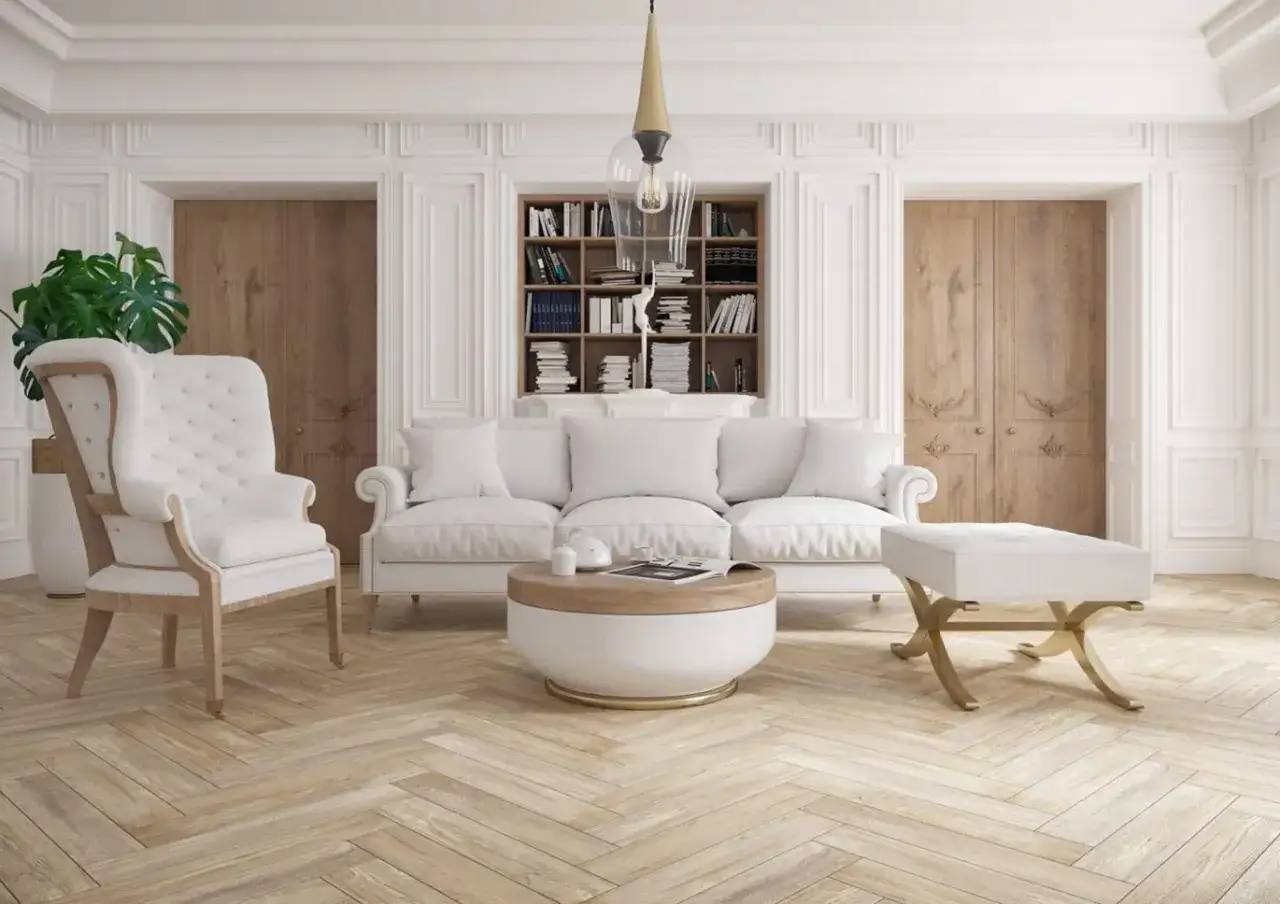 Elegancki salon z białymi meblami i sztukaterią ścienną. Zobacz, jak samodzielnie rozplanować ramki na ścianie, by stworzyć stylowe wnętrze.